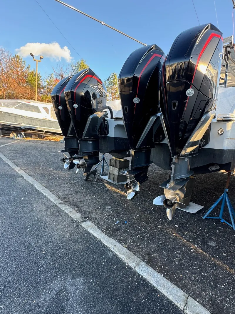 Slide: The Image of 2022 Invincible 40 Catamaran with triple outboard engines in a boatyard. - 5