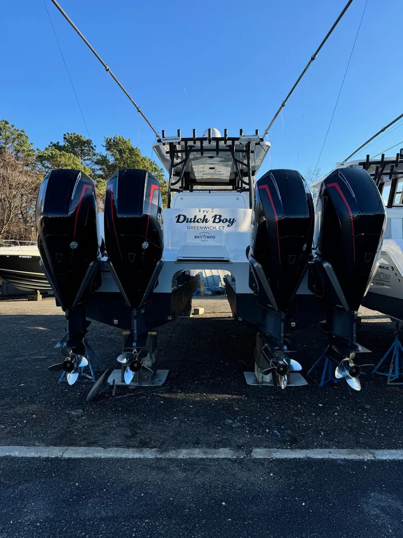 Slide: The Image of 2022 Invincible 40 Catamaran with four powerful outboard engines, docked outdoors. - 6