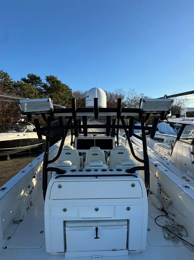 Slide: The Image of 2022 Invincible 40 Catamaran with seating and storage, docked under clear blue sky. - 8