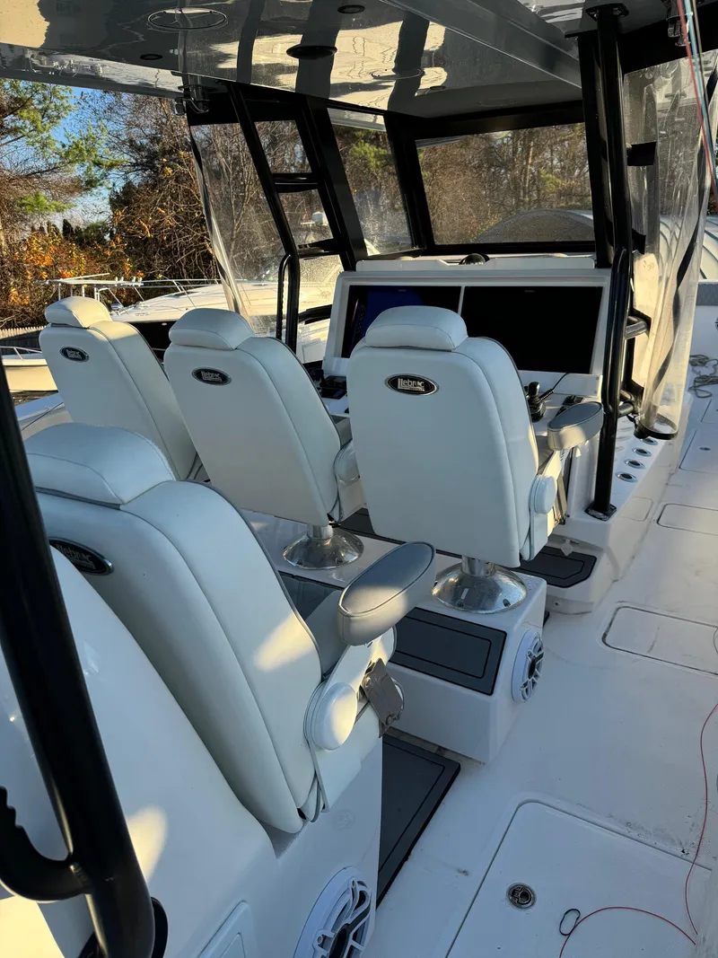 Slide: The Image of 2022 Invincible 40 Catamaran interior with white seating and modern dashboard. - 9
