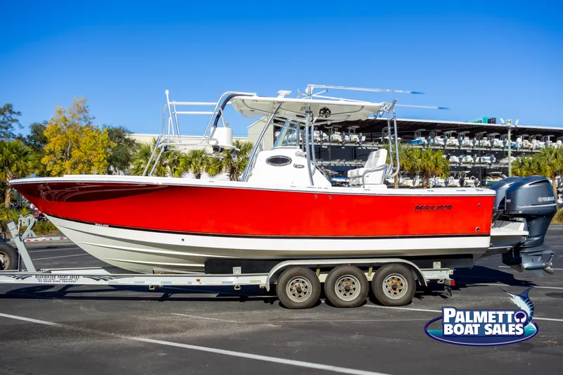 The Image of 2011 Regulator 28 boat with red hull on trailer at Palmetto Boat Sales. - 1