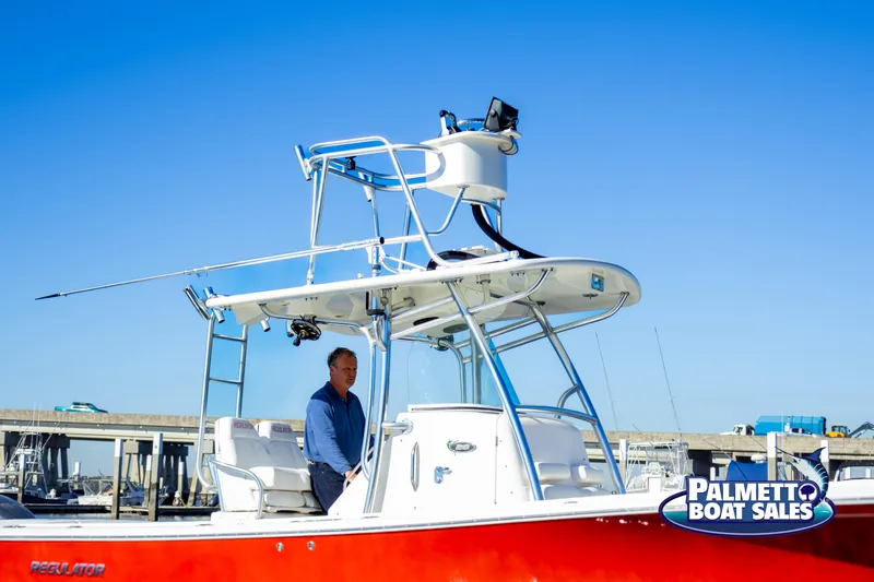 Slide: The Image of 2011 Regulator 28 boat with red hull at Palmetto Boat Sales. - 11