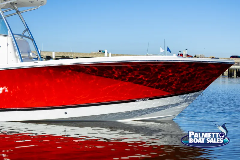 Slide: The Image of Red 2011 Regulator 28 boat on water, Palmetto Boat Sales logo visible. - 14