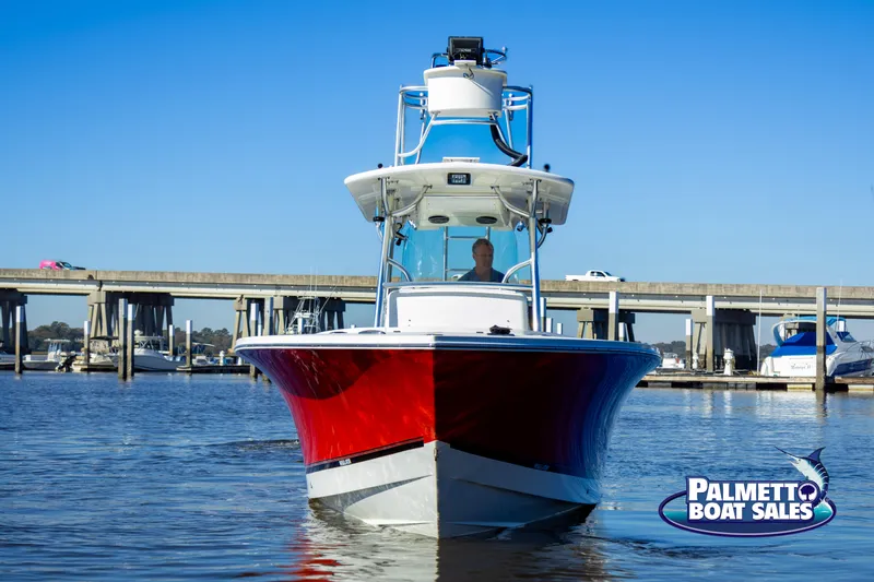 Slide: The Image of 2011 Regulator 28 boat with red hull on water, Palmetto Boat Sales logo visible. - 15