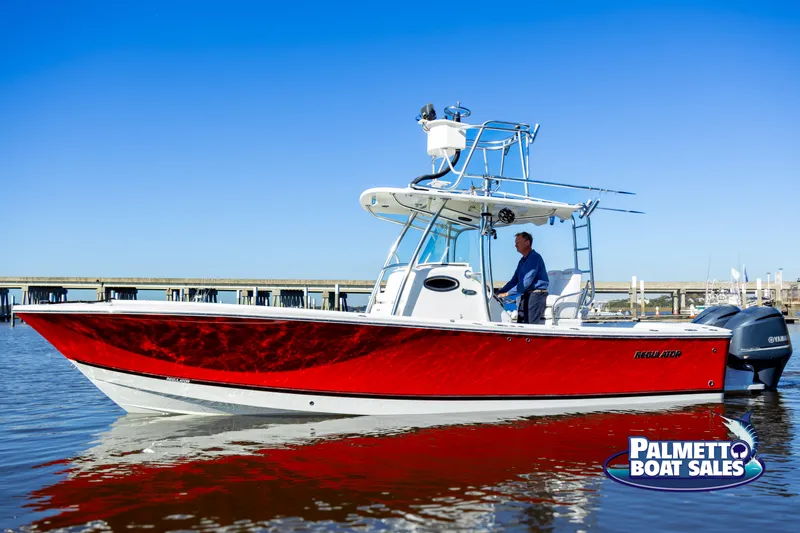 Slide: The Image of 2011 Regulator 28 boat with red hull on calm water, Palmetto Boat Sales logo visible. - 18