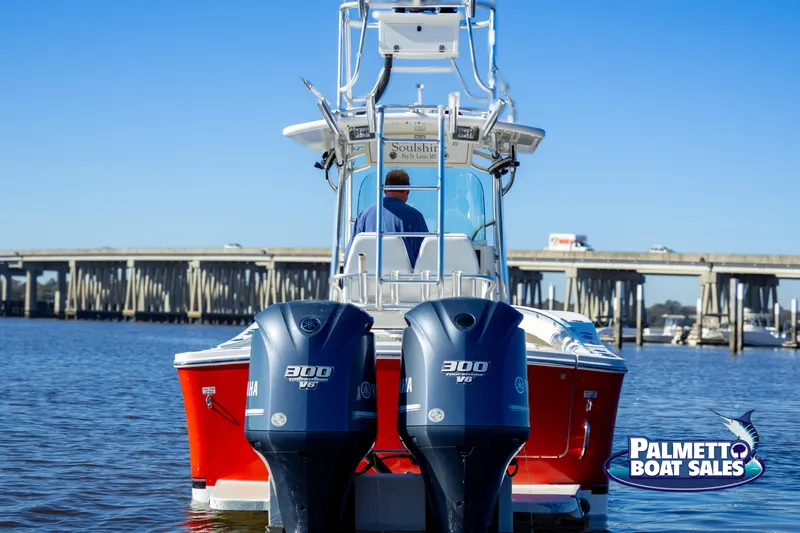 Slide: The Image of 2011 Regulator 28 boat with twin 300 HP engines on water, bridge in background. - 20