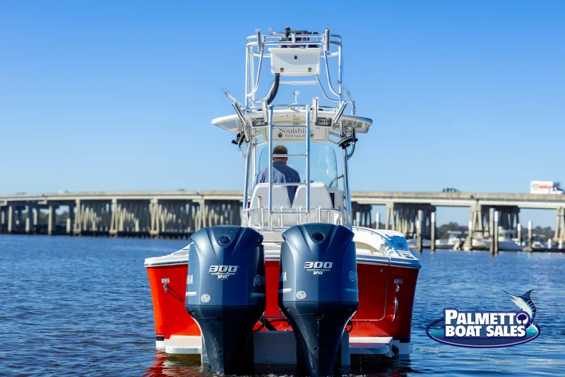 Slide: The Image of 2011 Regulator 28 boat with twin 300 HP engines on water, bridge in background. - 21