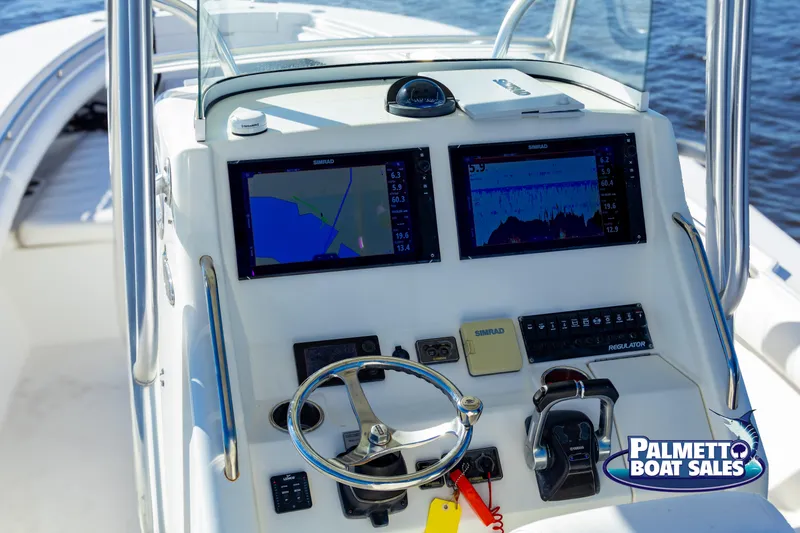 Slide: The Image of 2011 Regulator 28 boat dashboard with navigation screens and controls. - 22