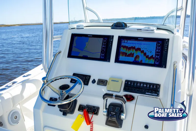 Slide: The Image of 2011 Regulator 28 boat dashboard with navigation screens and controls. - 24