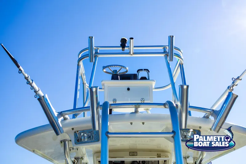 Slide: The Image of 2011 Regulator 28 boat with fishing rod holders, blue sky background. - 25