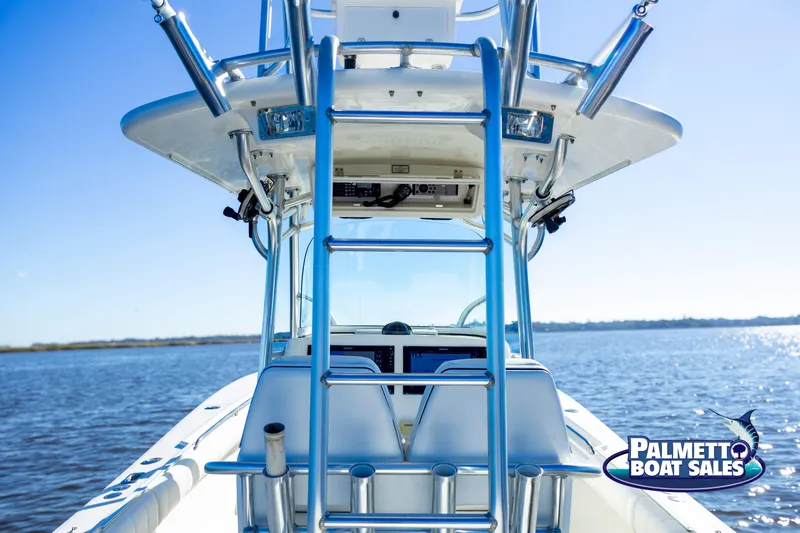 Slide: The Image of 2011 Regulator 28 boat on water, featuring a center console and ladder. - 26