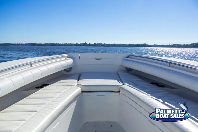 Slide: The Image of 2011 Regulator 28 boat interior with white seating, on calm water. - 28