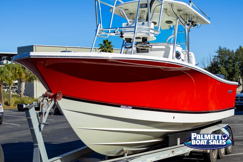 Slide: The Image of 2011 Regulator 28 boat with red hull on trailer at Palmetto Boat Sales. - 3