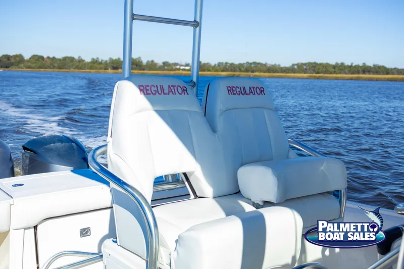 Slide: The Image of 2011 Regulator 28 boat seats on water, Palmetto Boat Sales logo visible. - 31