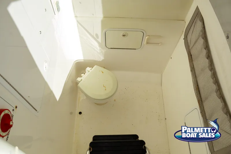 Slide: The Image of 2011 Regulator 28 boat interior with toilet and storage compartments. - 33