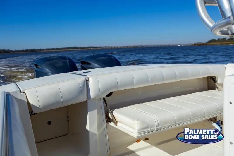 Slide: The Image of 2011 Regulator 28 boat with dual engines on open water, Palmetto Boat Sales logo visible. - 34