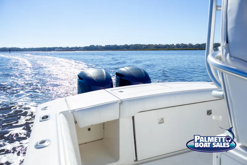 Slide: The Image of 2011 Regulator 28 boat on water, twin engines, Palmetto Boat Sales logo visible. - 38