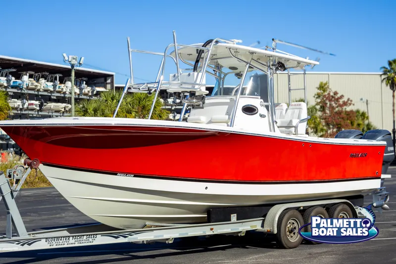 Slide: The Image of 2011 Regulator 28 boat with red hull on trailer at Palmetto Boat Sales. - 7