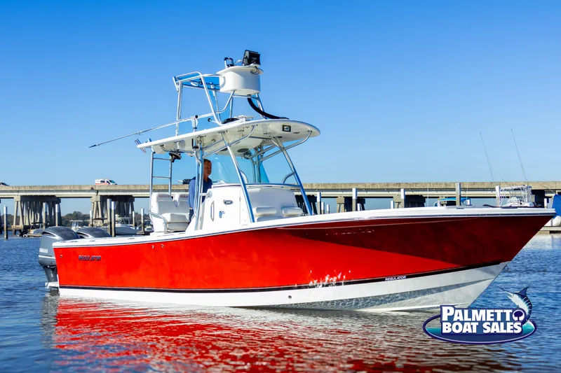 Slide: The Image of 2011 Regulator 28 boat with red hull on water, Palmetto Boat Sales logo visible. - 9
