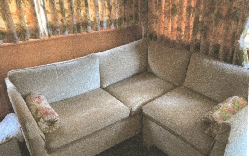 Slide: The Image of Beige L-shaped sofa in 1983 Egg Harbor 33 Convertible boat interior. - 12