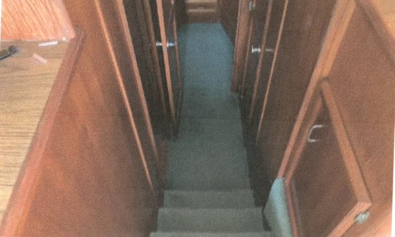Slide: The Image of Interior view of 1983 Egg Harbor 33 Convertible yacht hallway with wooden paneling. - 13