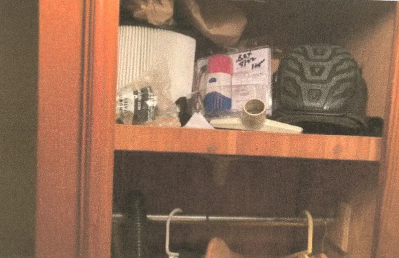 Slide: The Image of Cabinet interior with assorted items, including a helmet and household supplies. Egg Harbor 33 Convertible, 1983. - 17