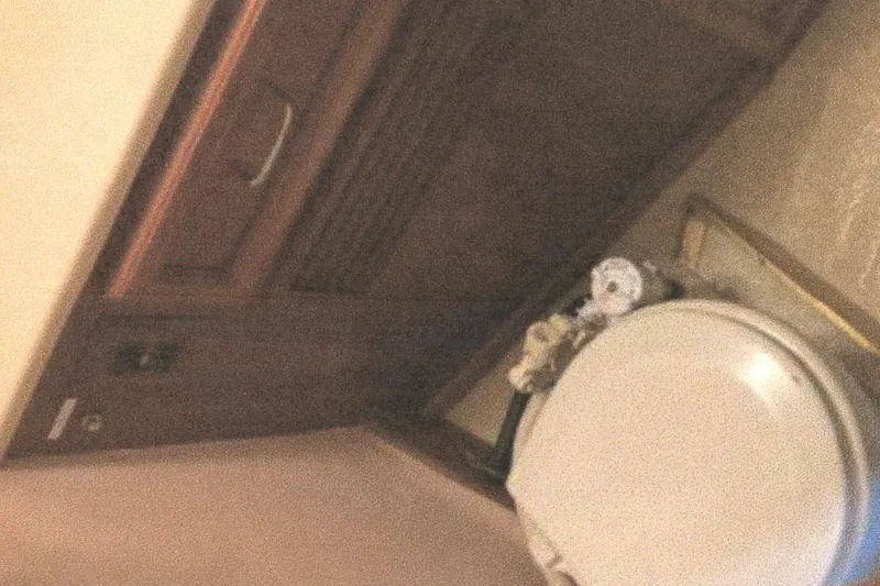 Slide: The Image of 1983 Egg Harbor 33 Convertible yacht bathroom with wooden cabinetry and toilet. - 20