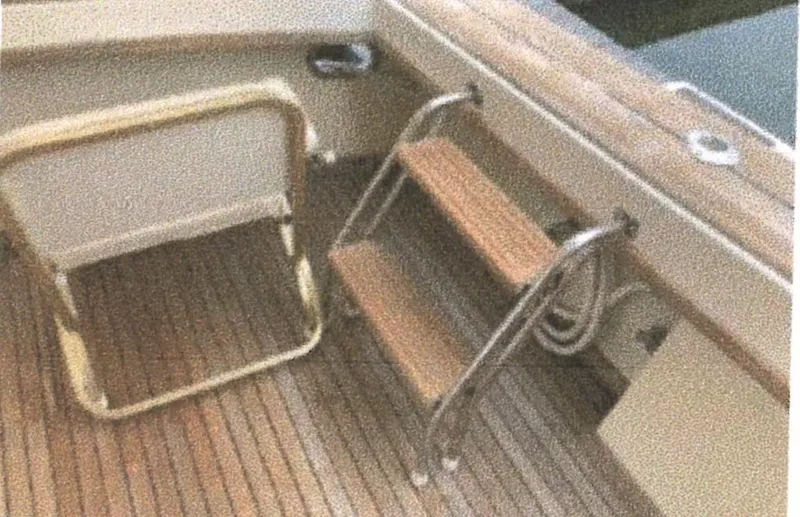 Slide: The Image of 1983 Egg Harbor 33 Convertible boat deck with wooden steps and railing. - 4