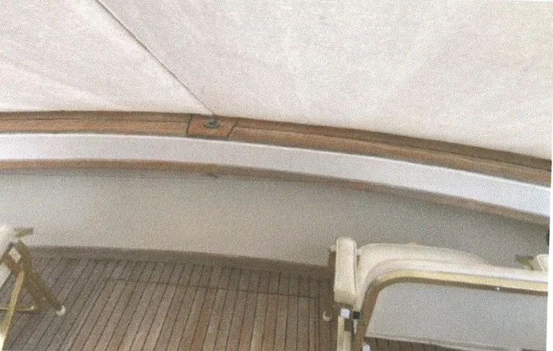 Slide: The Image of 1983 Egg Harbor 33 Convertible boat interior with wooden deck and seating. - 5