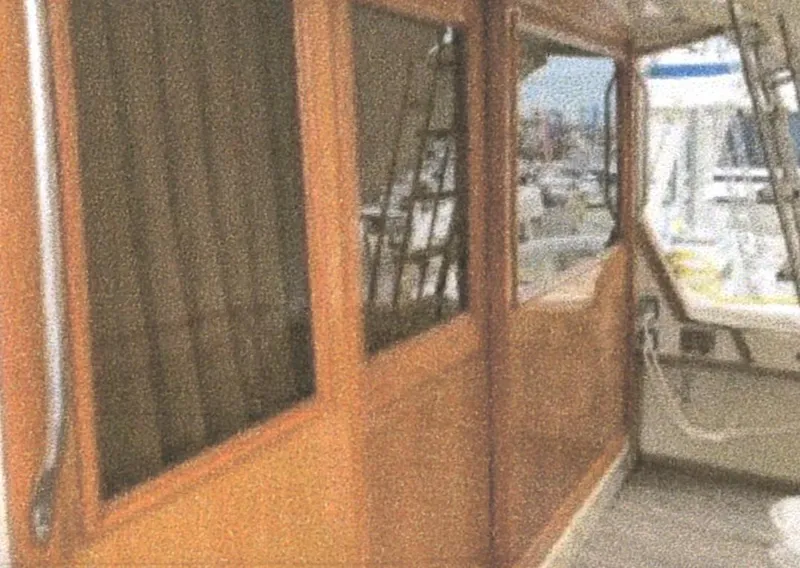 Slide: The Image of 1983 Egg Harbor 33 Convertible yacht with wooden interior and marina view. - 6
