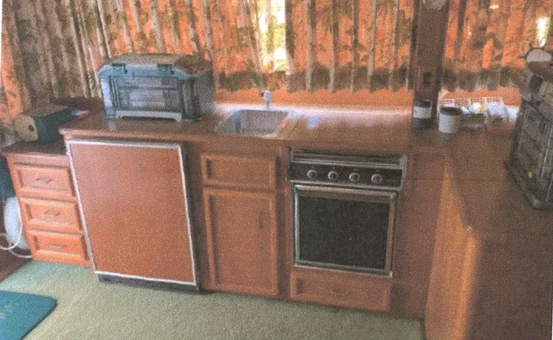 Slide: The Image of 1983 Egg Harbor 33 Convertible kitchen with wood cabinetry, sink, and appliances. - 8