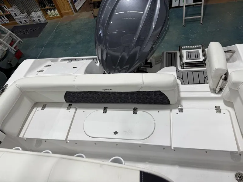 Slide: The Image of 2025 Tidewater 220 LXF boat interior with seating and engine view. - 10