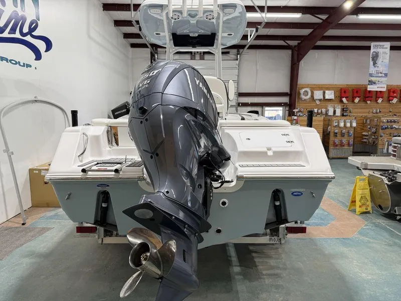 Slide: The Image of 2025 Tidewater 220 LXF boat with powerful outboard motor in showroom. - 12