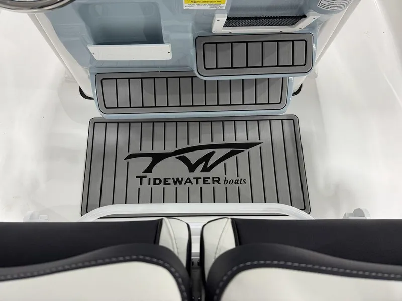 Slide: The Image of Tidewater 220 LXF 2025 boat interior with branded flooring and seating. - 13