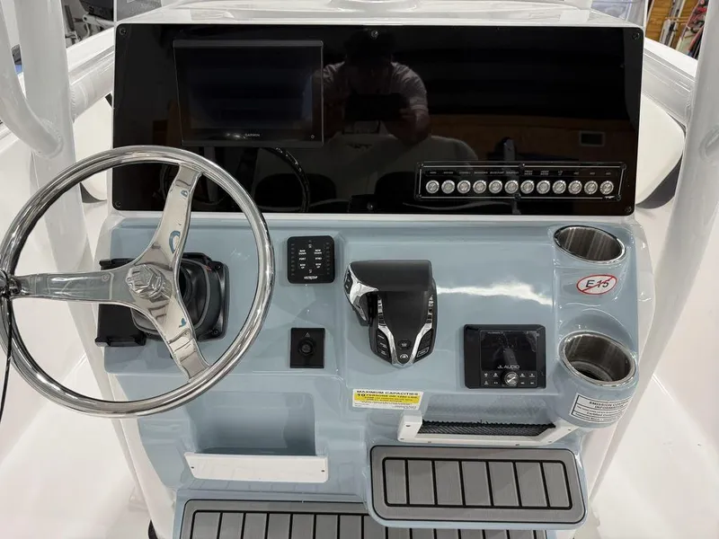 Slide: The Image of 2025 Tidewater 220 LXF boat dashboard with steering wheel and control panel. - 14