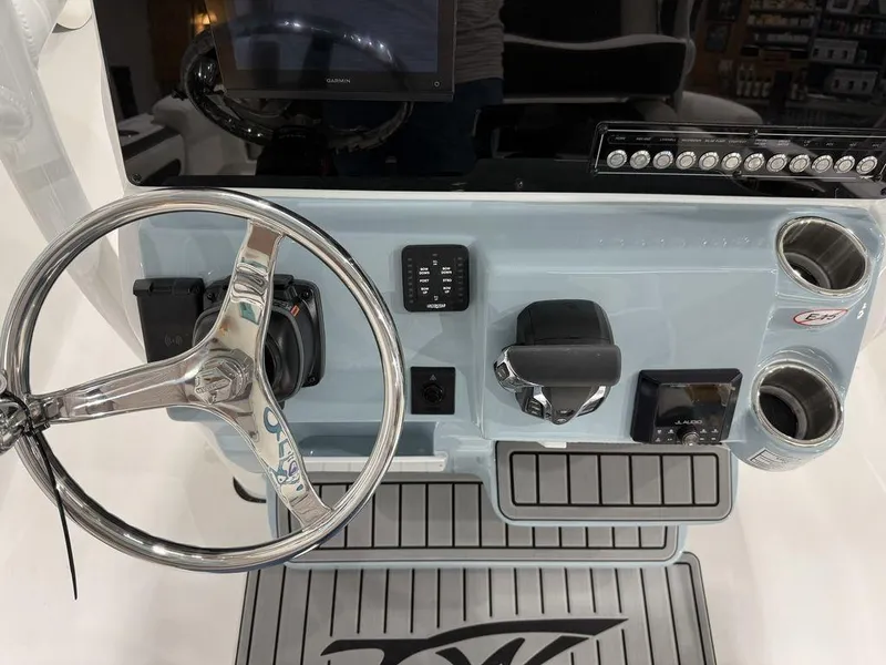 Slide: The Image of 2025 Tidewater 220 LXF boat dashboard with steering wheel and controls. - 16