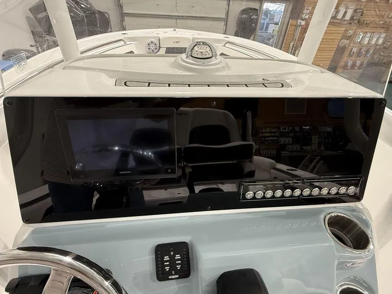 Slide: The Image of 2025 Tidewater 220 LXF boat dashboard with modern controls and navigation system. - 18