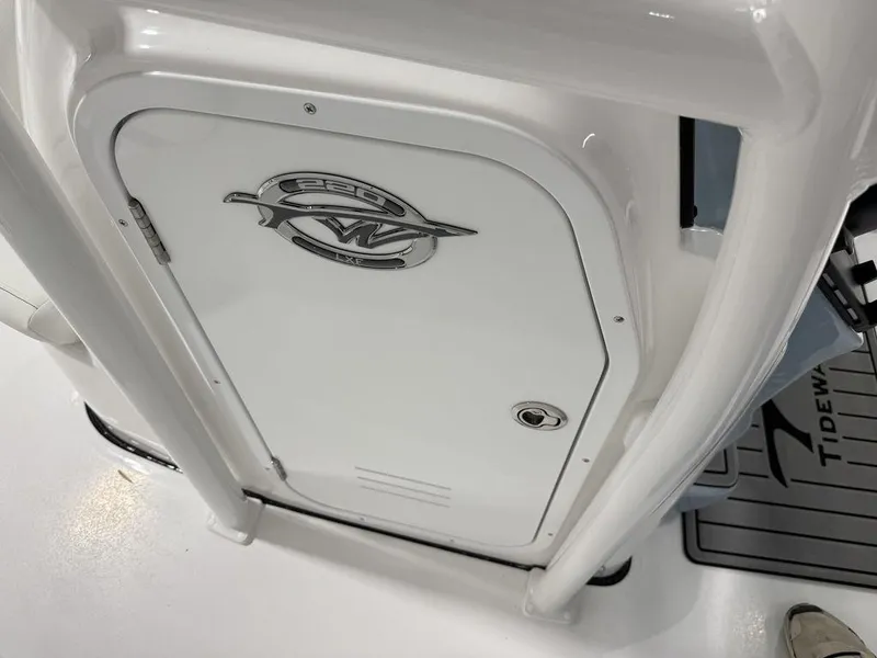 Slide: The Image of 2025 Tidewater 220 LXF boat console with storage compartment and logo. - 20