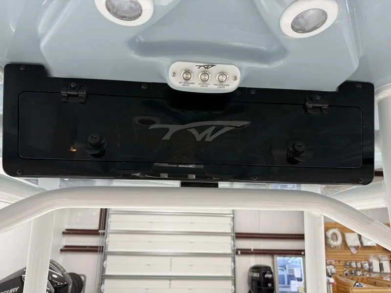 Slide: The Image of 2025 Tidewater 220 LXF boat console with lighting and storage compartment. - 23