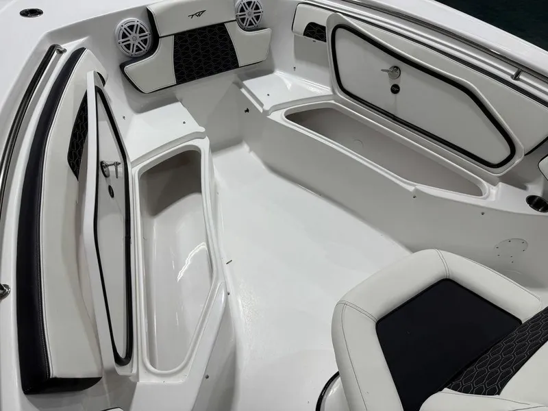 Slide: The Image of 2025 Tidewater 220 LXF boat interior with storage compartments and seating. - 26