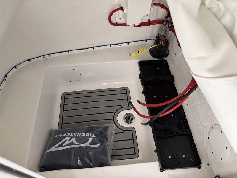Slide: The Image of 2025 Tidewater 220 LXF boat interior with wiring and storage compartment. - 28