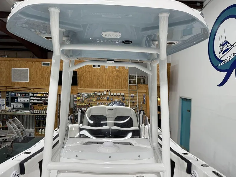 Slide: The Image of 2025 Tidewater 220 LXF boat interior with T-top and seating in showroom. - 29