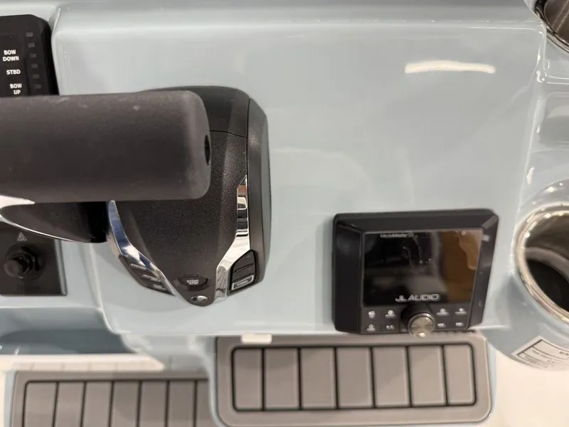Slide: The Image of Tidewater 220 LXF 2025 boat dashboard with controls and JL Audio system. - 31