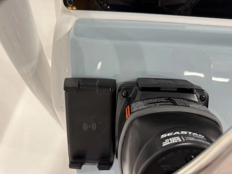 Slide: The Image of Close-up of 2025 Tidewater 220 LXF boat's control panel with wireless charging pad. - 33