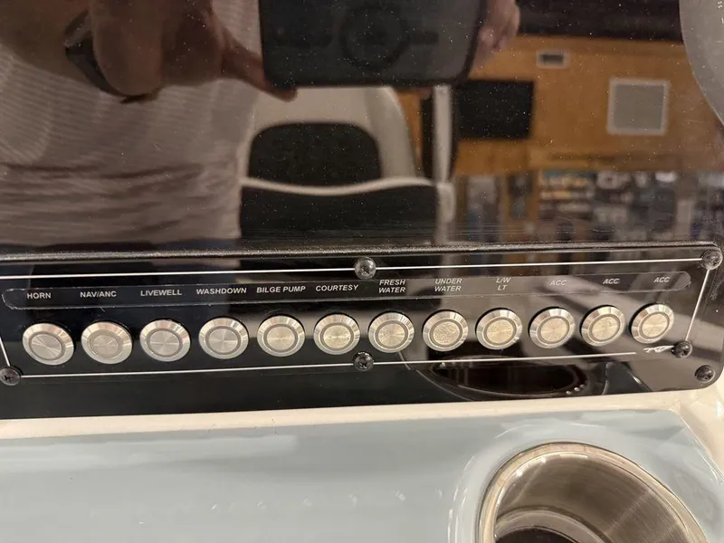 Slide: The Image of Control panel of 2025 Tidewater 220 LXF boat with labeled buttons. - 34