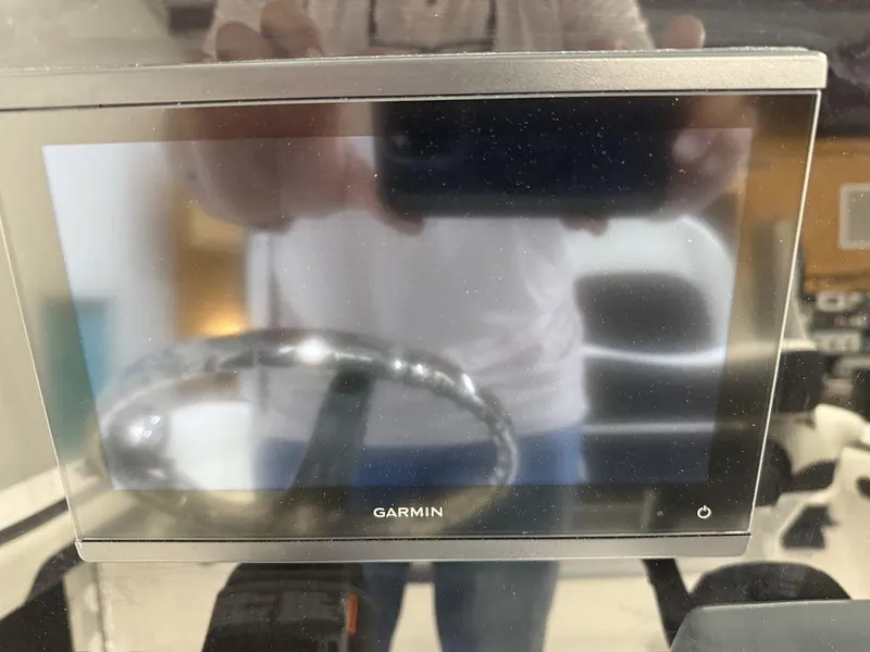 Slide: The Image of Garmin display on 2025 Tidewater 220 LXF boat dashboard, reflecting steering wheel. - 35