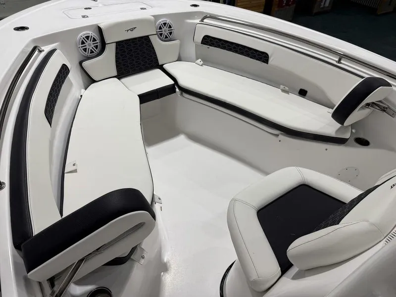 Slide: The Image of 2025 Tidewater 220 LXF boat interior with white seating and speakers. - 37