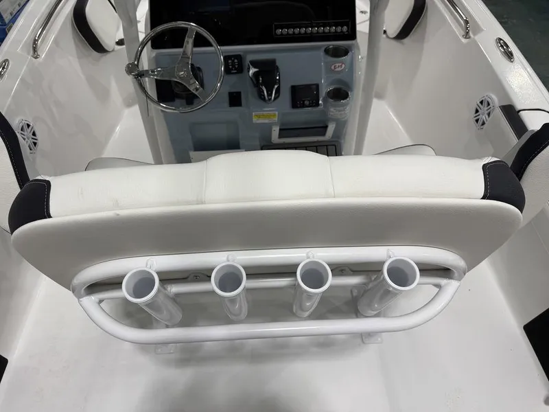 Slide: The Image of 2025 Tidewater 220 LXF boat interior with steering wheel and rod holders. - 7