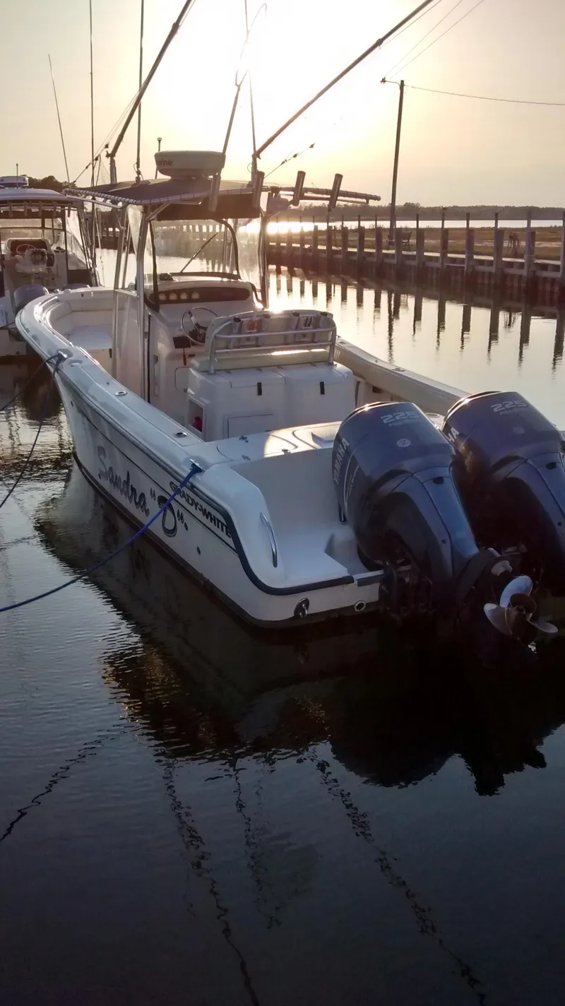 Slide: The Image of 2005 Grady-White Release 283 boat docked at sunset with twin outboard motors. - 4