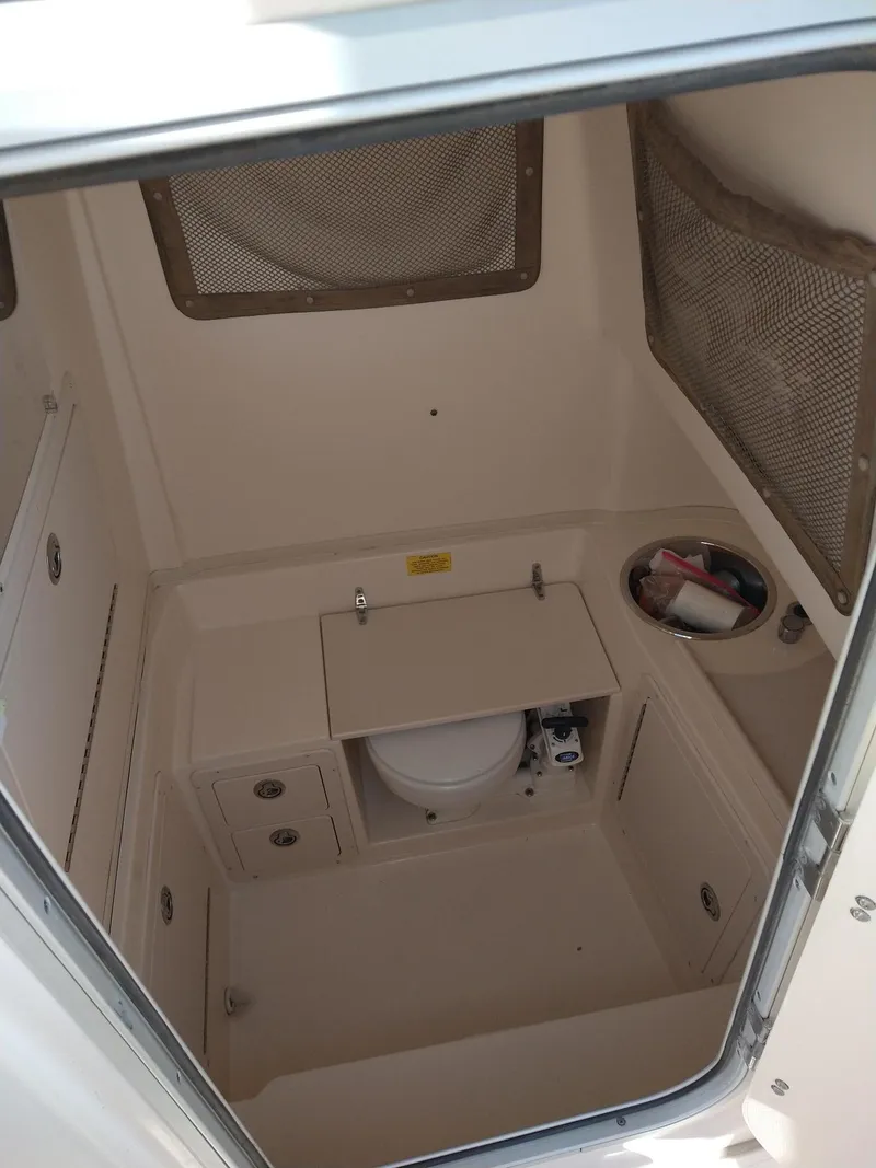 Slide: The Image of 2005 Grady-White Release 283 boat interior with compact bathroom amenities. - 7